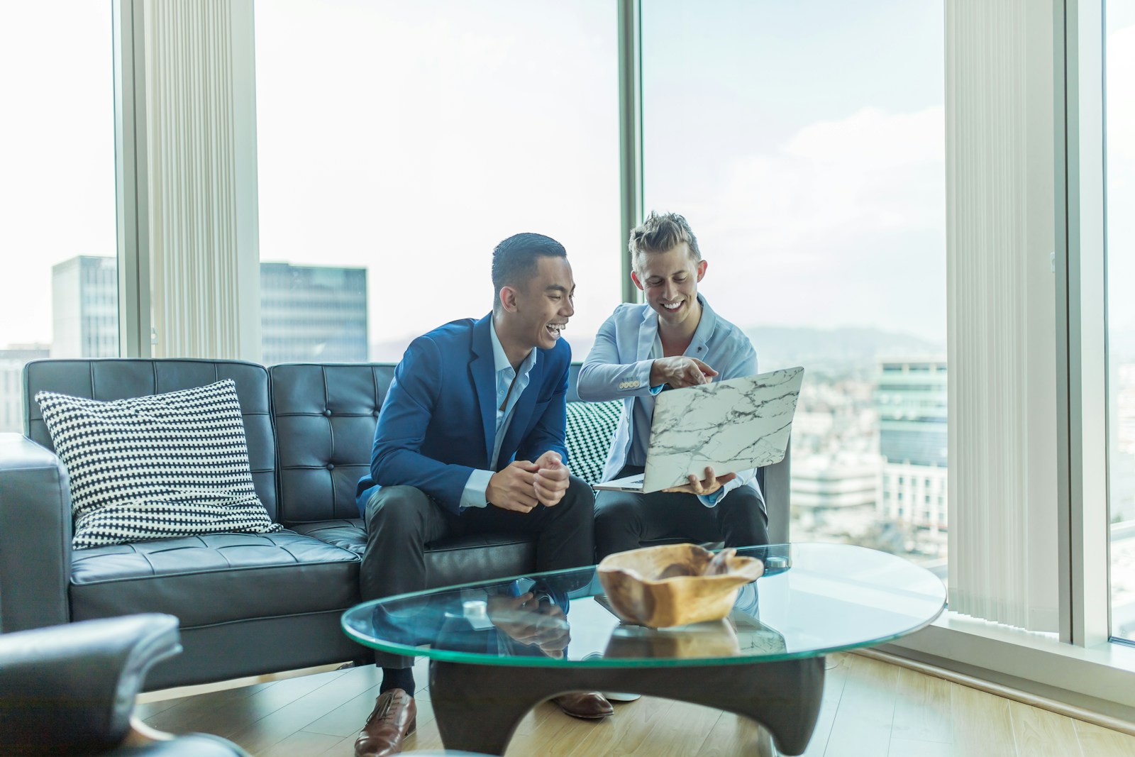 two men in suit sitting on sofadiscussing business insurance / commercial insurance