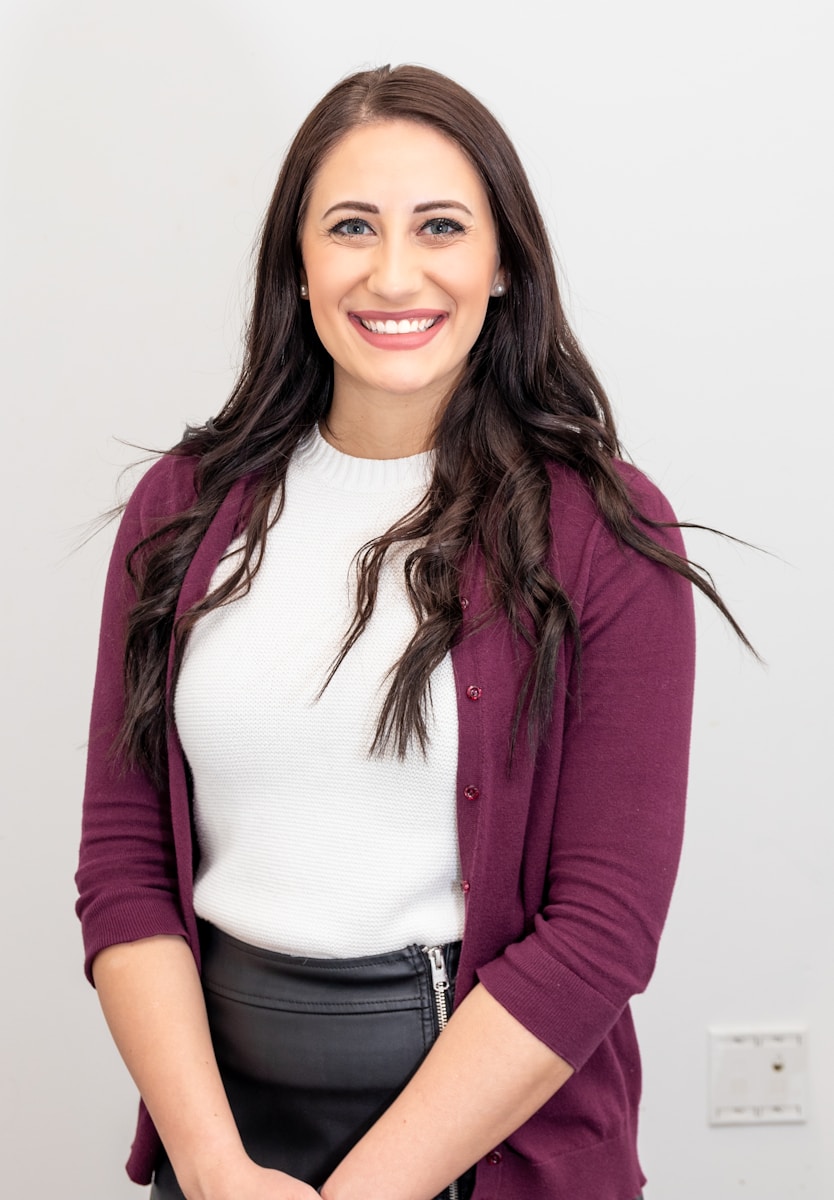 independent agent woman in red cardigan smiling